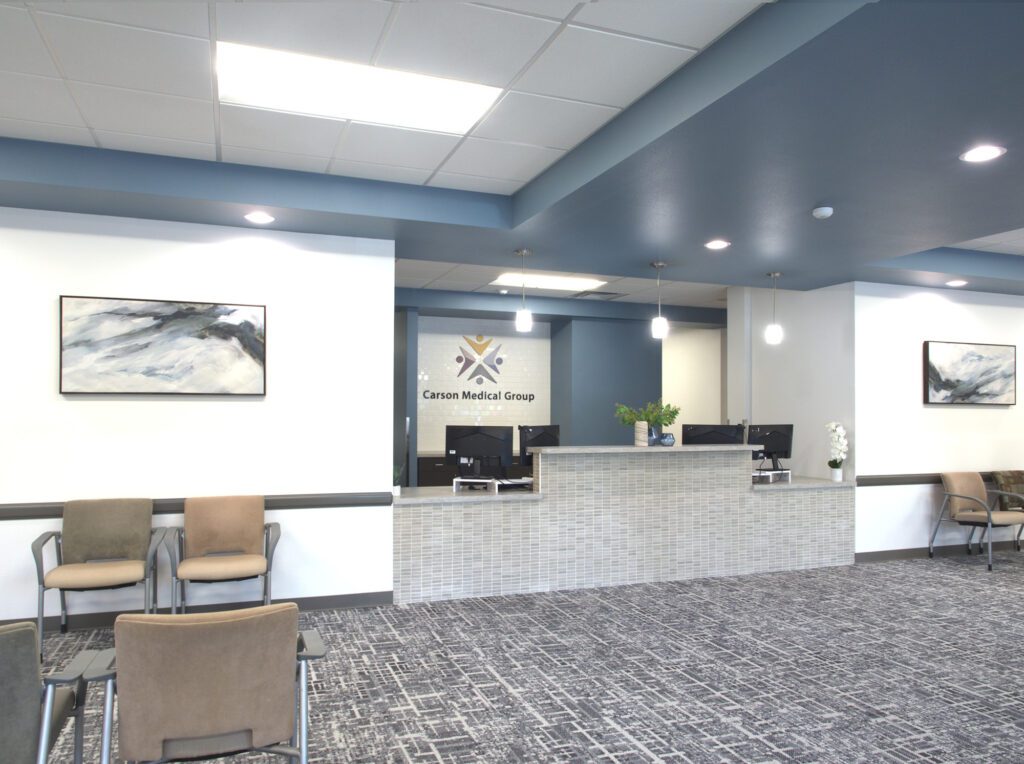 Modern front desk and waiting area in a commercial office remodel, designed by remodeling contractors Reno NV