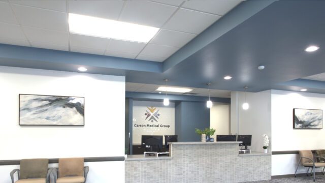 Modern front desk and waiting area in a commercial office remodel, designed by remodeling contractors Reno NV